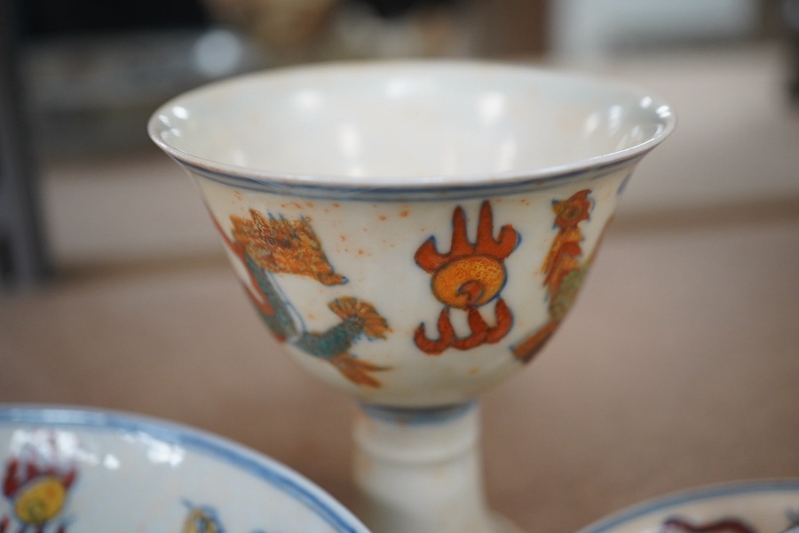 A pair of Chinese pedestal cups and three saucers. Condition - one cup severely damaged